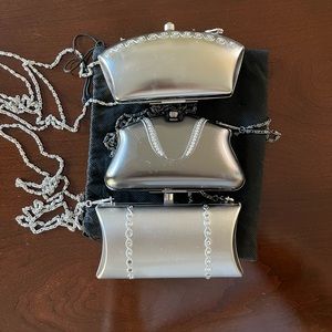 Three metal, cross body mini bags.